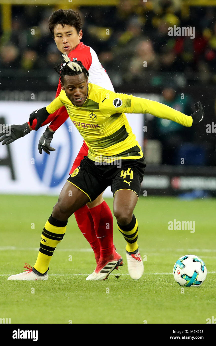 Dortmund. 26th Feb, 2018. Michy Batshuayi (front) of Borussia Dortmund vies with Koo Ja-Cheol of FC Augsburg during the Bundesliga match between Borussia Dortmund and FC Augsburg at the Signal Iduna Park in Dortmund Germany, Feb. 26, 2018. The match ended with a draw 1-1. Credit: Joachim Bywaletz/Xinhua/Alamy Live News Stock Photo