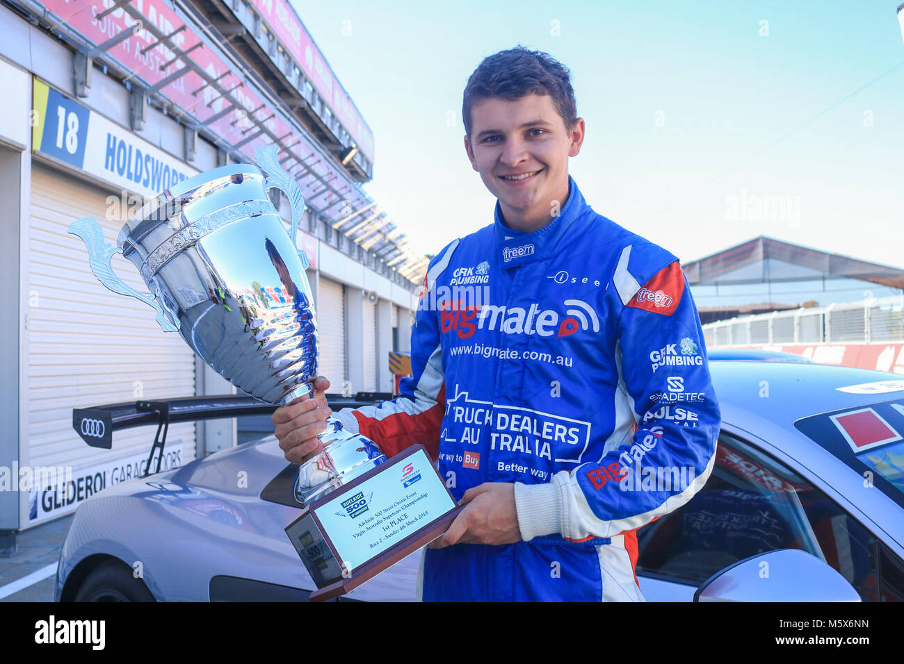Adelaide, Australia. 27th Feb, 2018. 22 year old rookie Supercar racing driver Todd Hazelwood who will compete in   the 2018 Virgin Australia Supercars Championship with Matt Stone Racing in the No. 35 Ford FG X Falcon unveils the new trophy at trackside for the 20th anniversary of the Adelaide 500  which  is expected to draw large crowds for the four day motorsport racing event beginning March 1. Todd Hazlewood is Winner of the 2017 Dunlop Super2 Series Credit: amer ghazzal/Alamy Live News Stock Photo