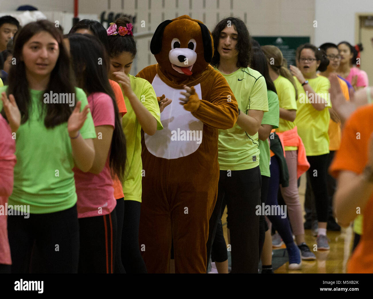 Houston, Texas, USA. 26th Feb, 2018. The principal of Awty International School Tom Beuscher dressed in a dog costume dances during the Year of the Dog performance in Houston, Texas, the United States on Feb. 26, 2018. The Awty International School in Houston, Texas Monday presented the Year of the Dog performance to observe the Chinese Lunar New Year to a crowd of 2,000. Credit: Yi-Chin Lee/Xinhua/Alamy Live News Stock Photo