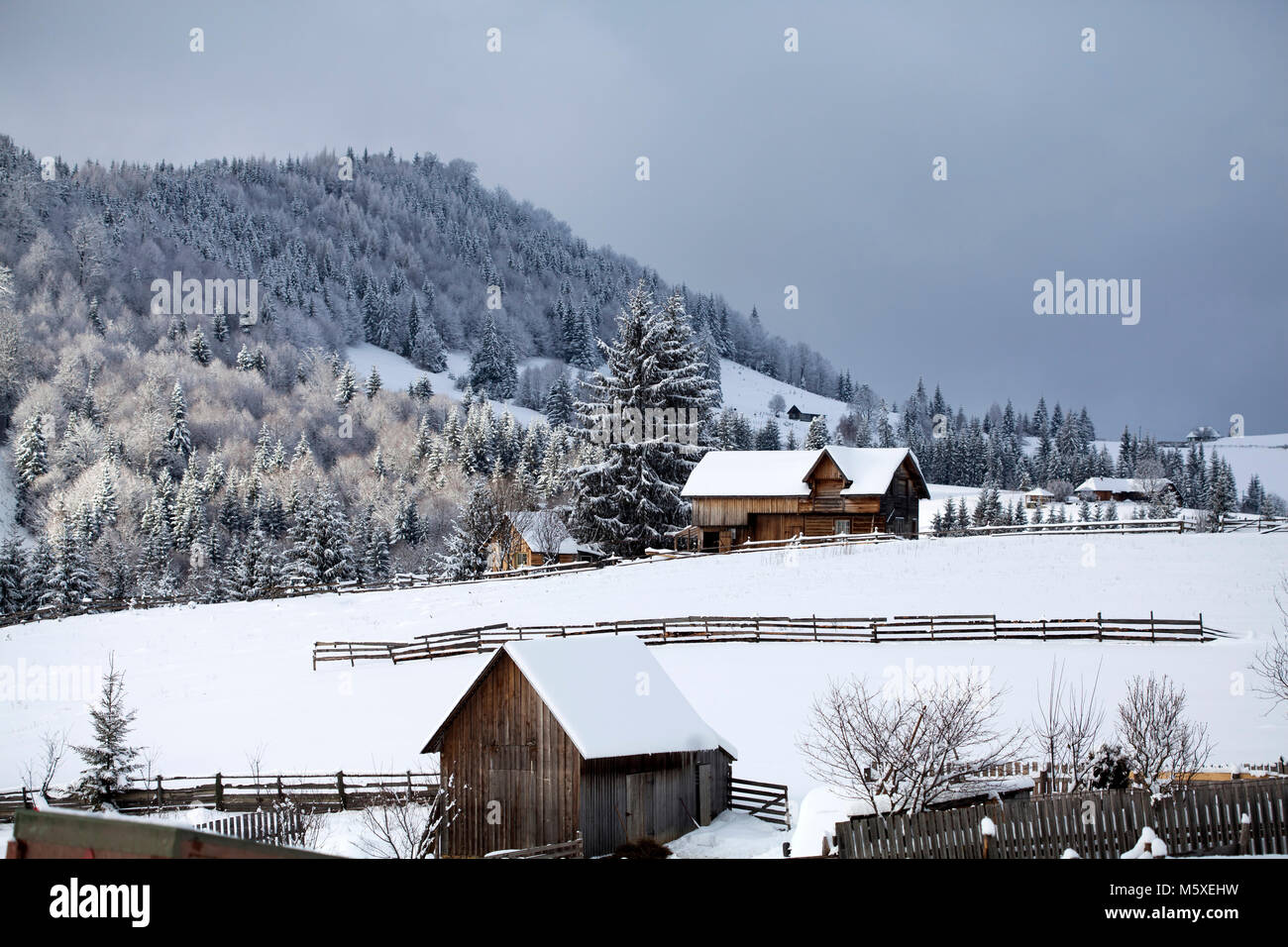 Small Romanian village in the Carpathians covered with snow Stock Photo ...