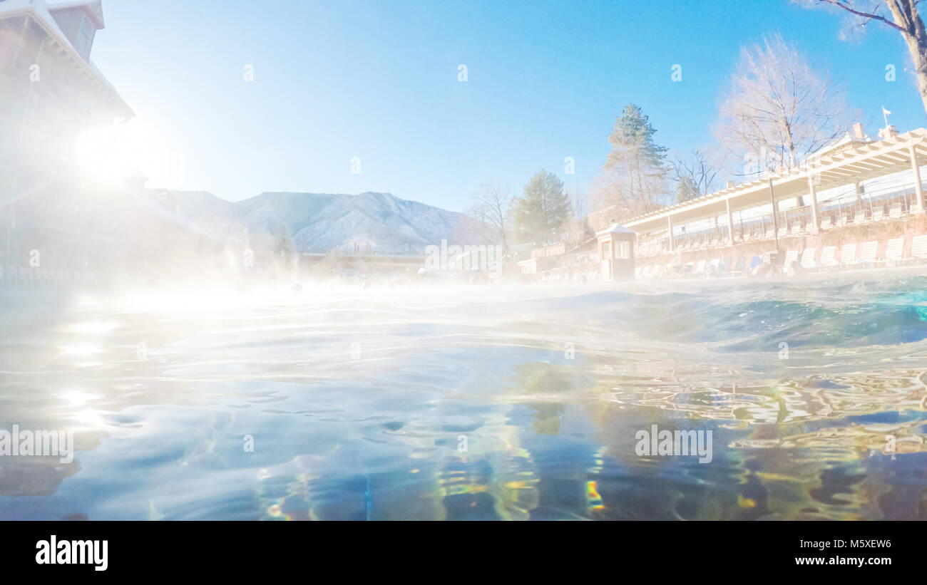 Swimming in outdoor hot springs pool in the Winter. Stock Photo