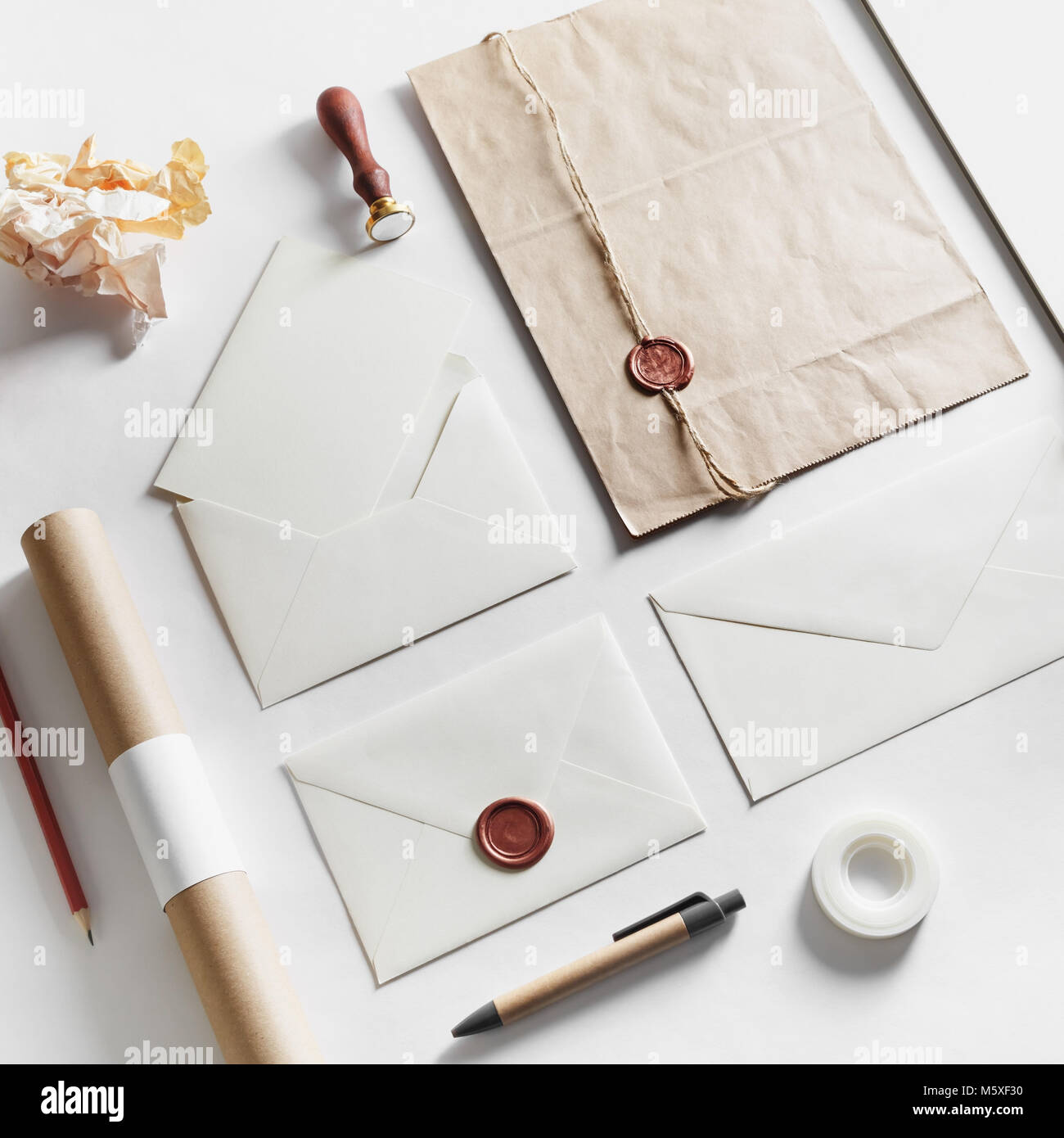 Vintage still life with postal accessories. Blank stationery and envelopes on paper background. Responsive design mockup. Stock Photo