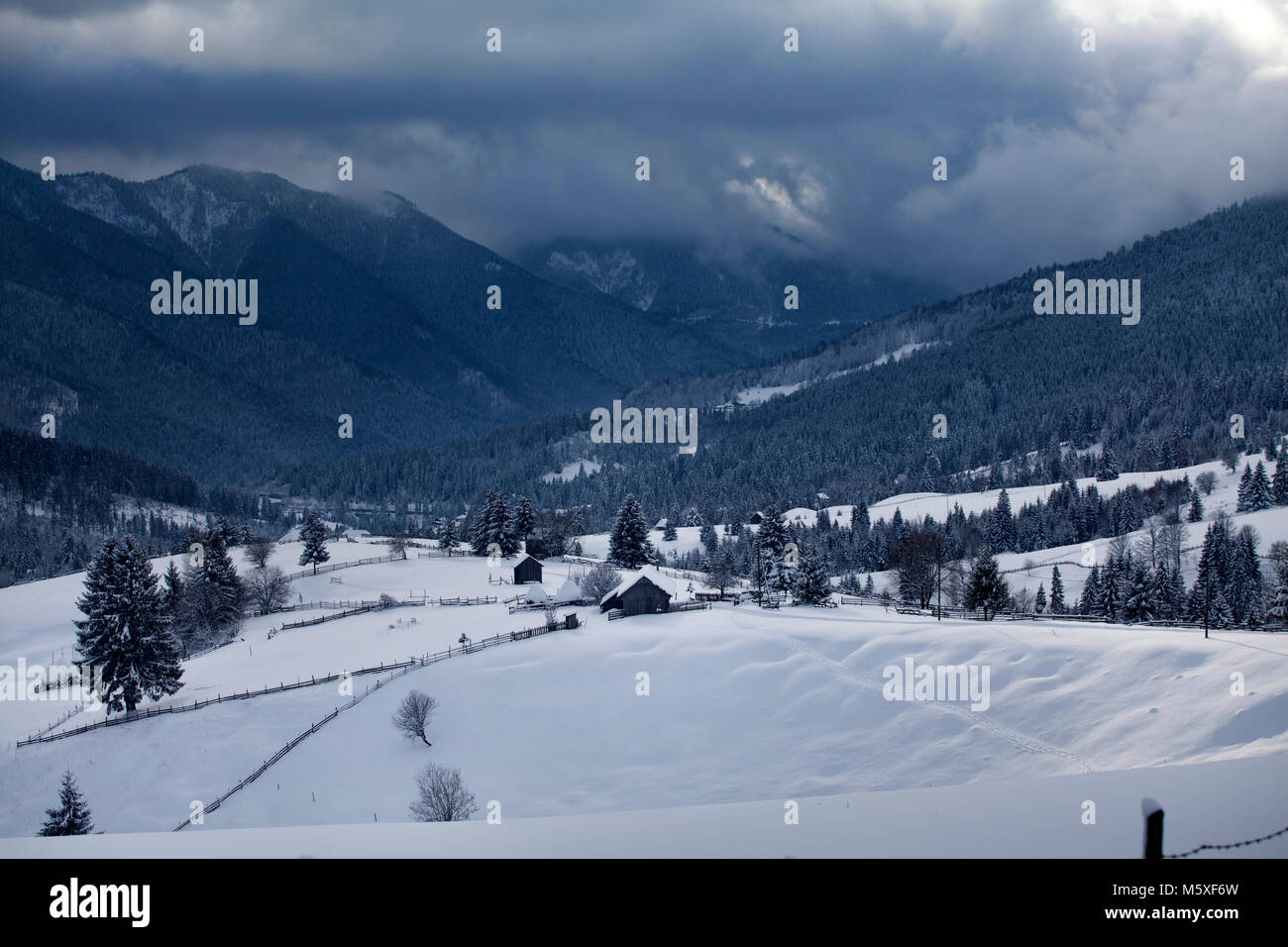 Small Romanian village in the Carpathians covered with snow Stock Photo ...