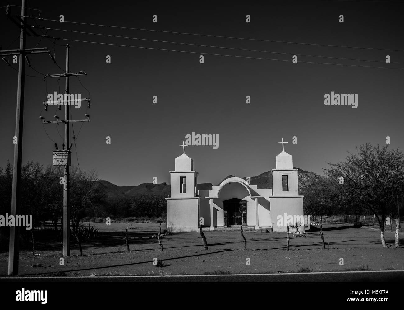 White church El Valle village, in the community of Cumpas and los Hoyos. The place is part of the Sierra route in Sonora, Mexico. fence, siege, prongs Stock Photo