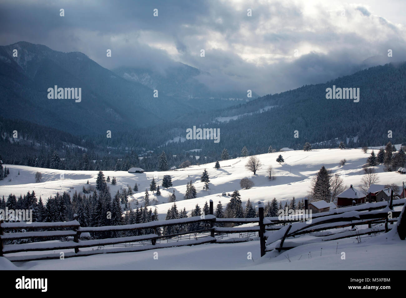 Small Romanian village in the Carpathians covered with snow Stock Photo ...
