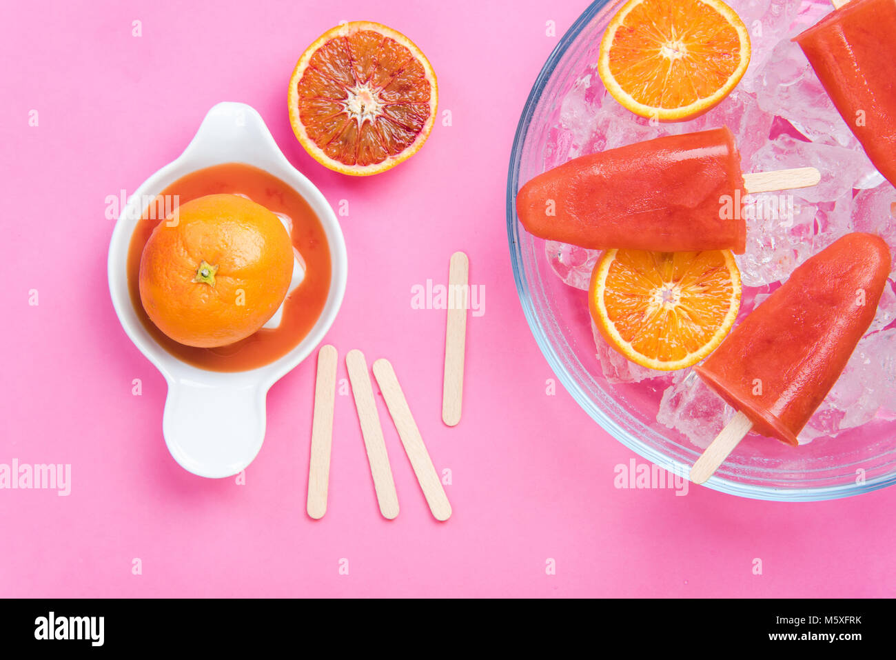 Making homemade healthy popsicles from blood orange juice Stock Photo