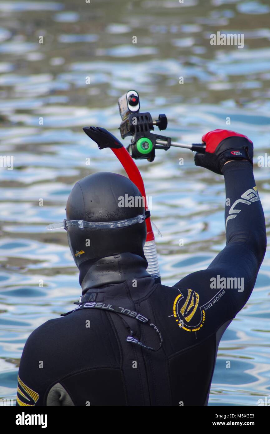 British Snorkeller at Beach, Torquay, South Devon, UK. In Wetsuit with Action Camera