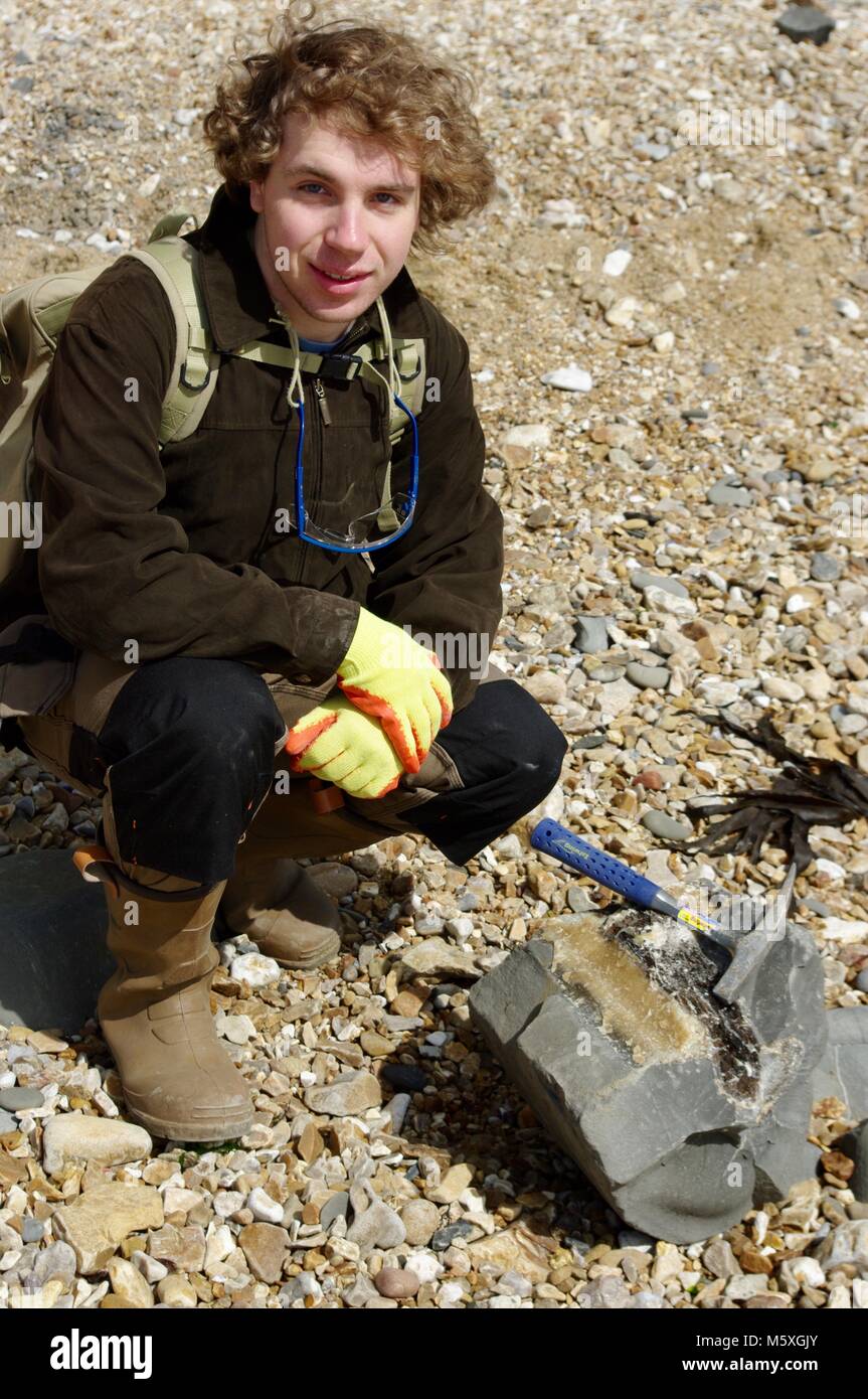 Young Handsome British Geologist, Fossil Hunting on Charmouth Beach, West Dorset. Jurassic Coast