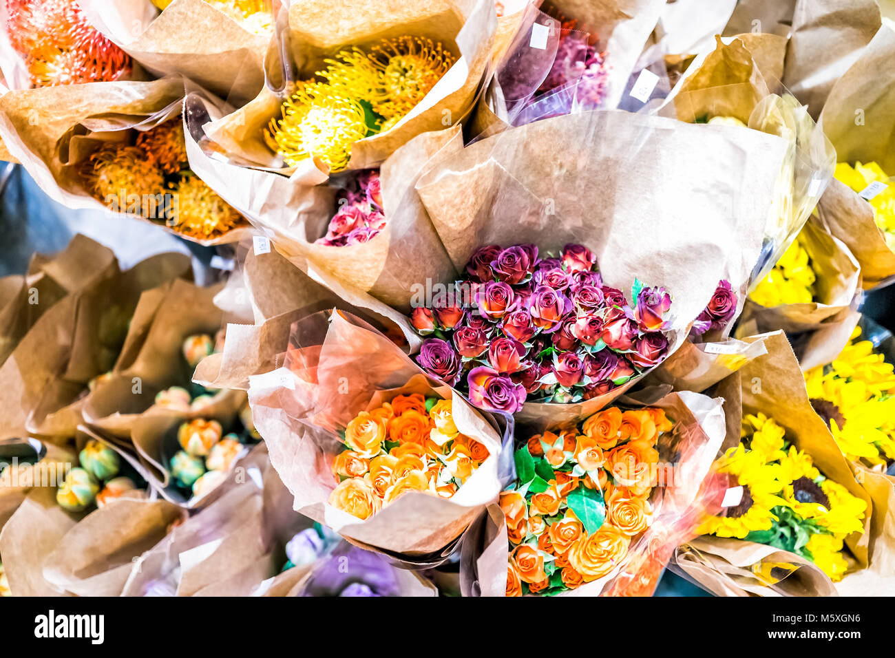 Colorful bouquets with many yellow sunflowers in flower store hires