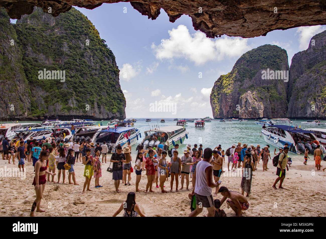Maya Bay Beach, Ko Phi Phi Le Island, Thailand, are overcrowded with tourists because it is now a honeypot or bucket list tourism destination Stock Photo