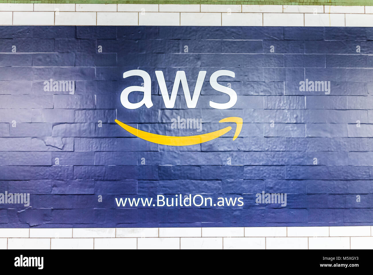 New York City, USA - October 30, 2017: Amazon Web Services AWS advertisement ad sign closeup in underground transit platform in NYC Subway Station, wa Stock Photo
