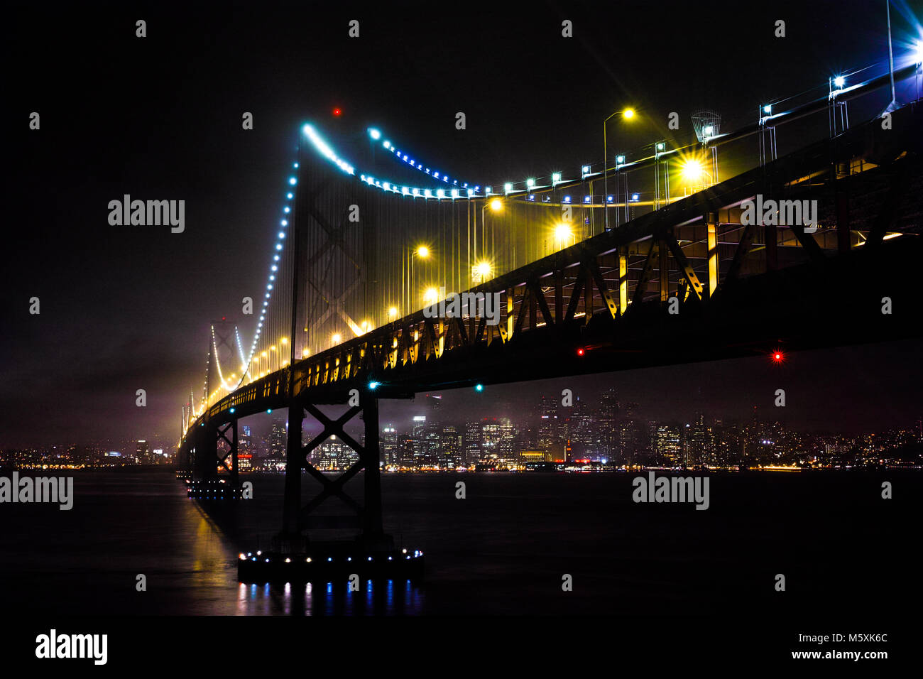 Illuminated San Francisco Oakland Bay Bridge at night Stock Photo