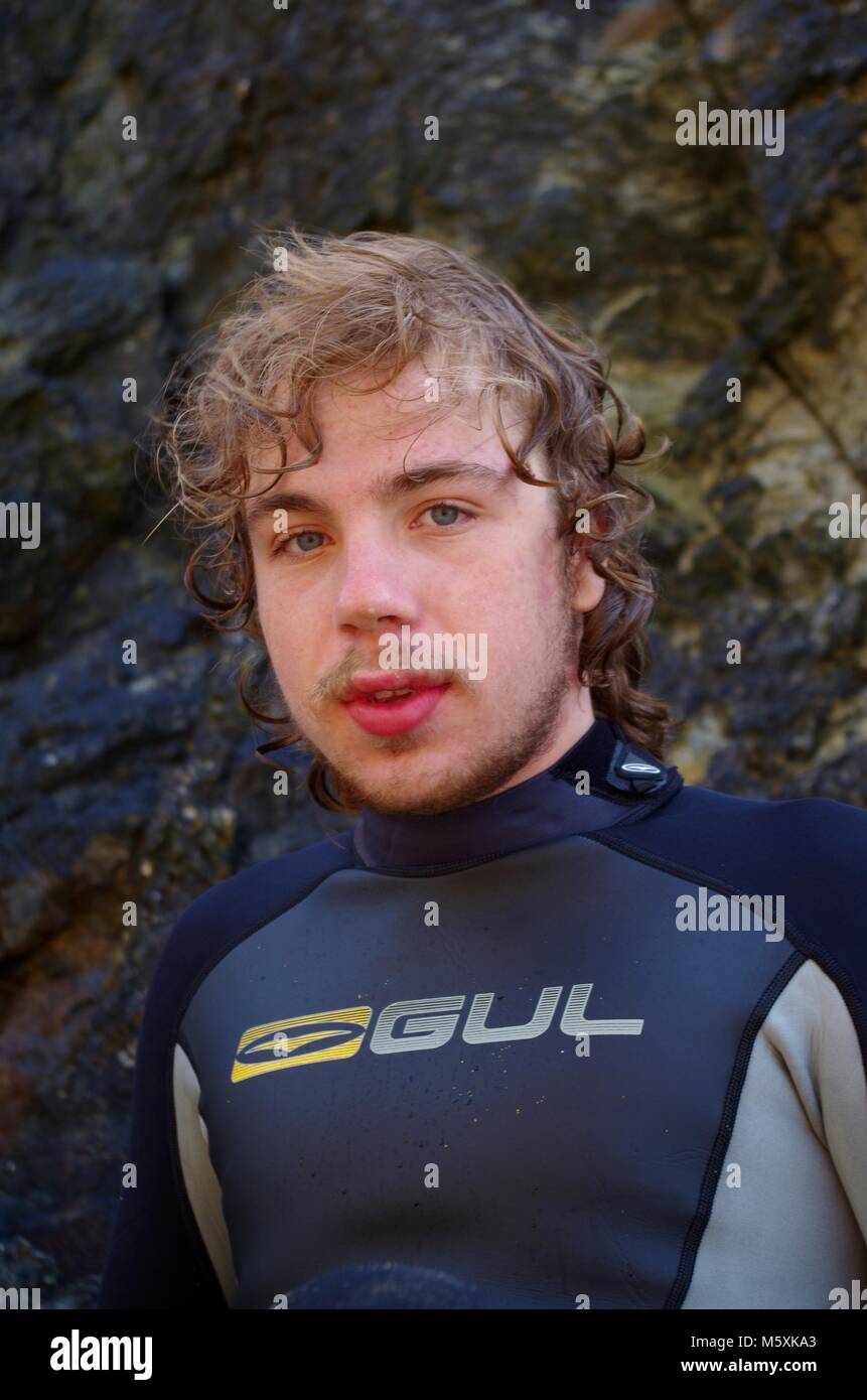 Young, Ruggedly Handsome British Surfer, in a Wetsuit on Holywell Beach, North Cornwall, UK
