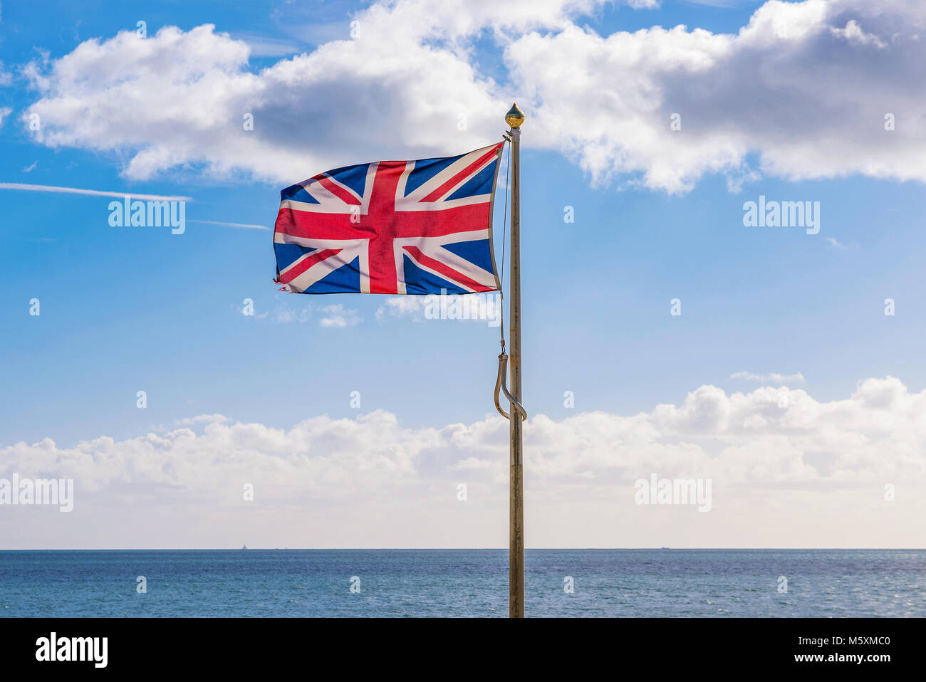 British flag waving by the ocean Stock Photo Alamy