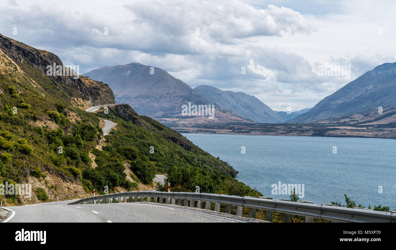 Winding road towards mountains around Lake Wakatipu, New Zealand Stock Photo