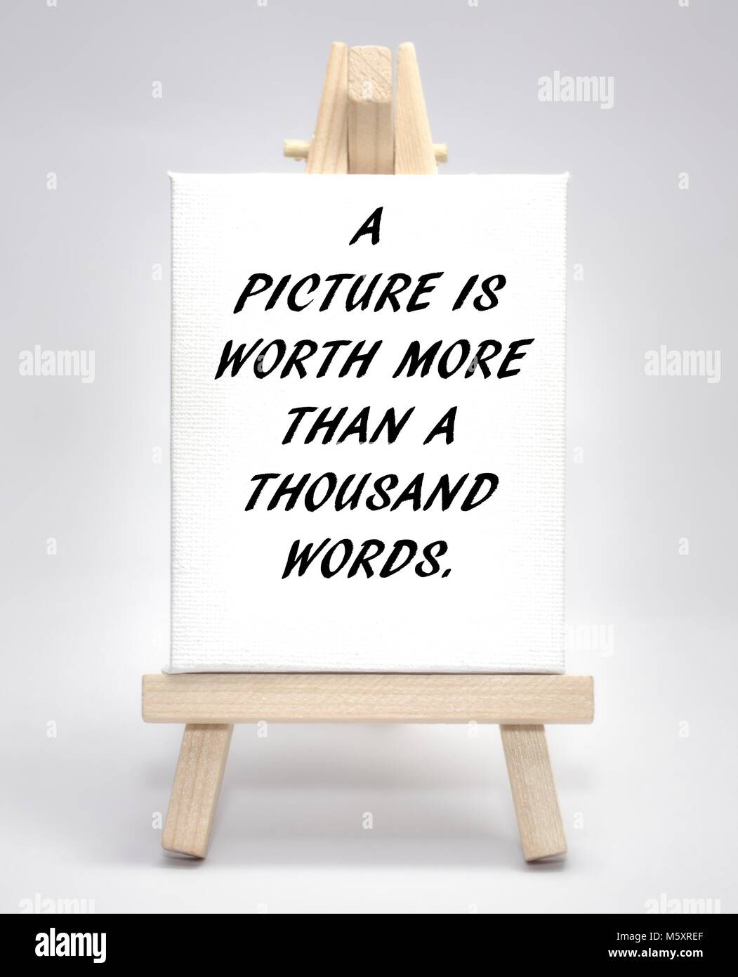 A picture is worth more than a thousand words concept white canvas artist easel Stock Photo