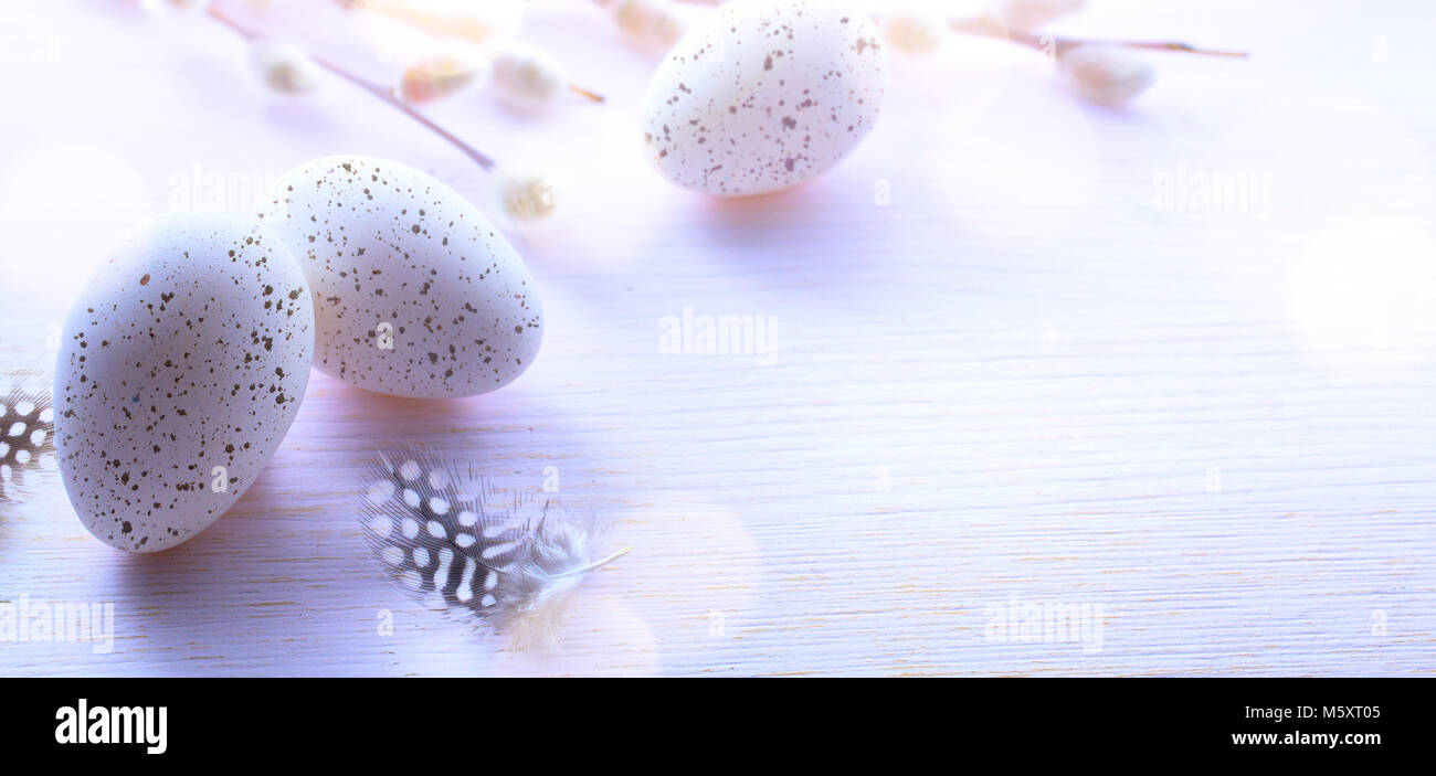 Easter background with Easter eggs and spring flowers on pink table ...