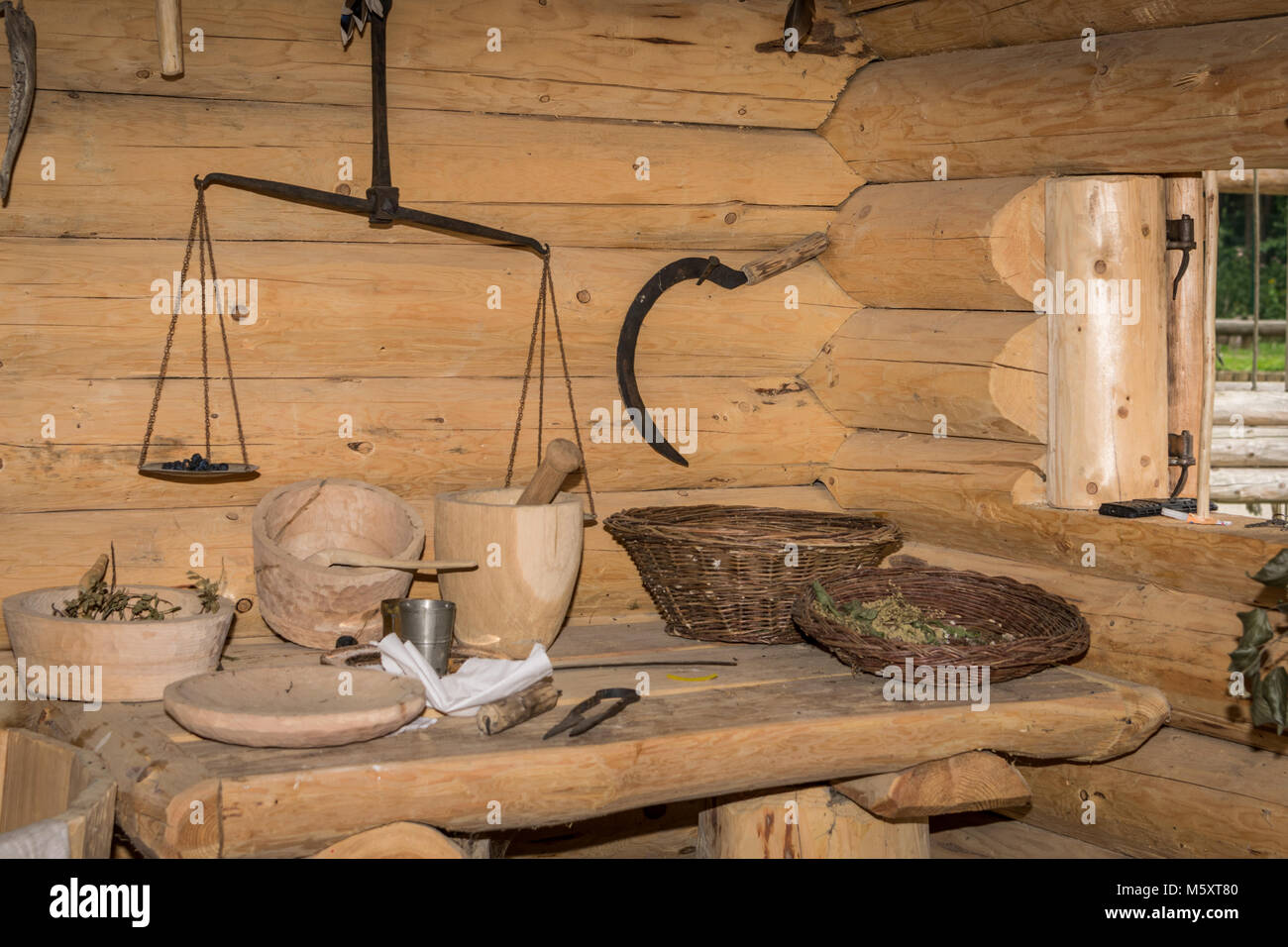 Tables of herbalist with scale and baskets Stock Photo