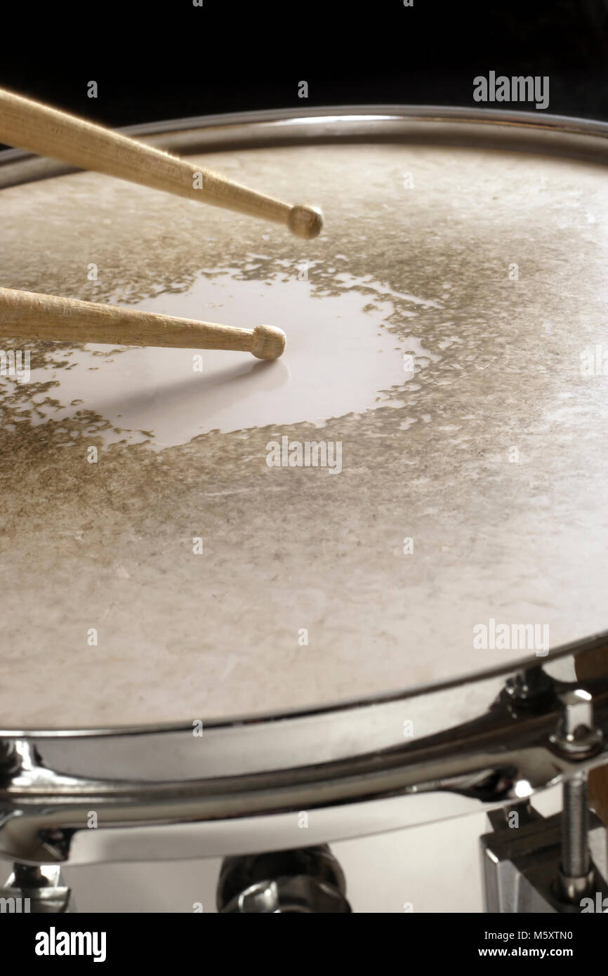 Photo of drumsticks playing on a well-worn snare drum Stock Photo - Alamy
