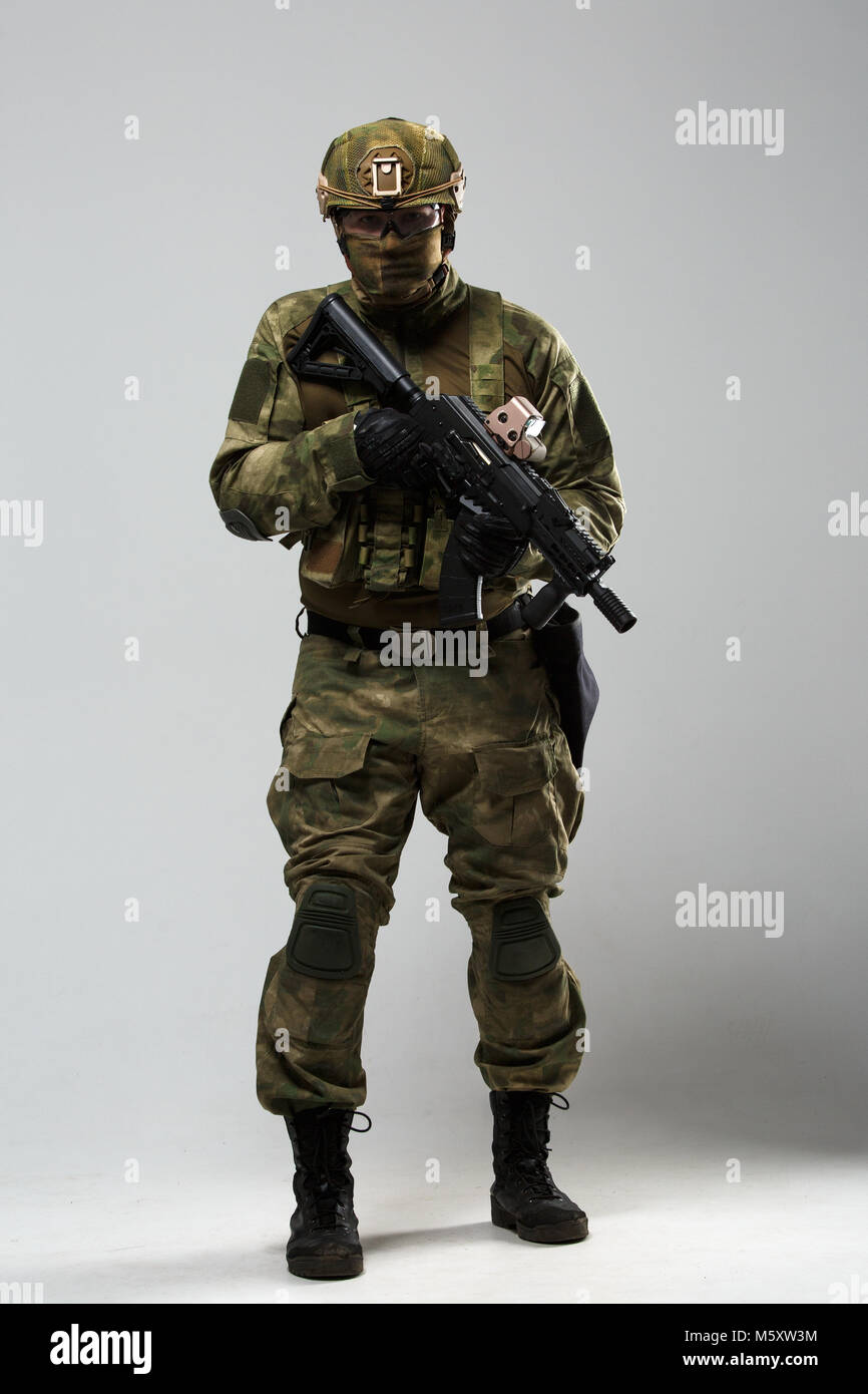 Full-length photo of military man in camouflage with gun Stock Photo ...