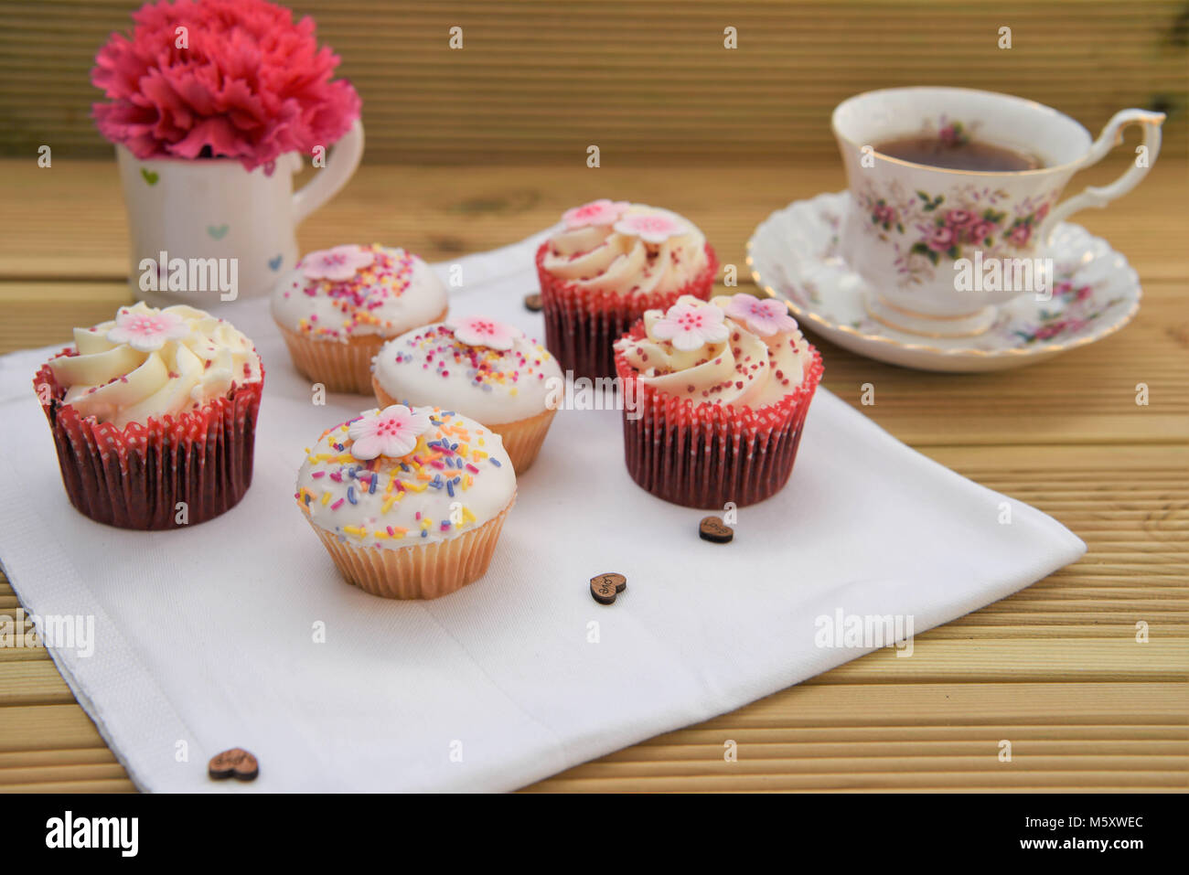 delicious home made food of little cakes and cup of tea with flowers Stock Photo