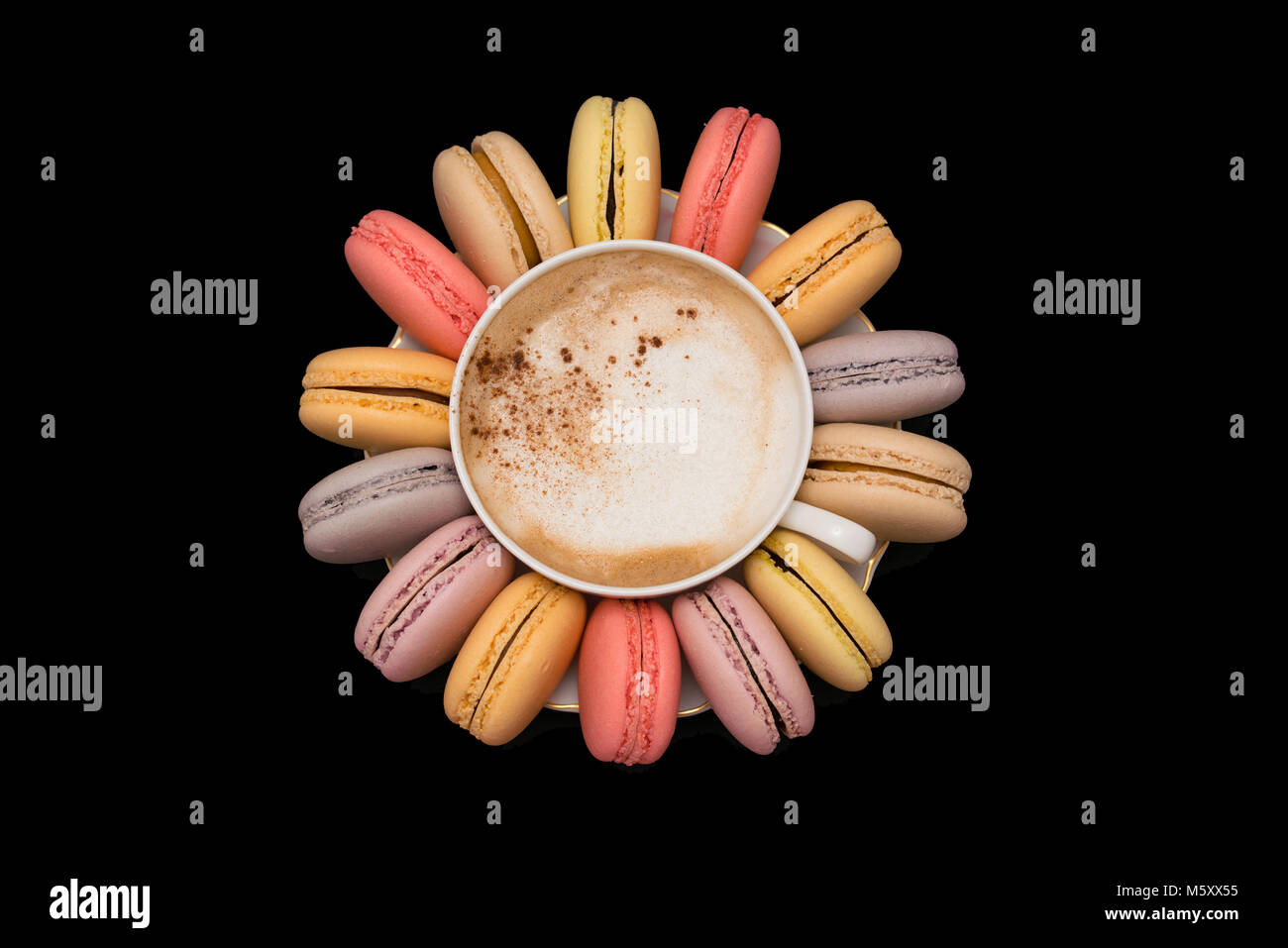 Pastel macarons around a coffee cup Stock Photo