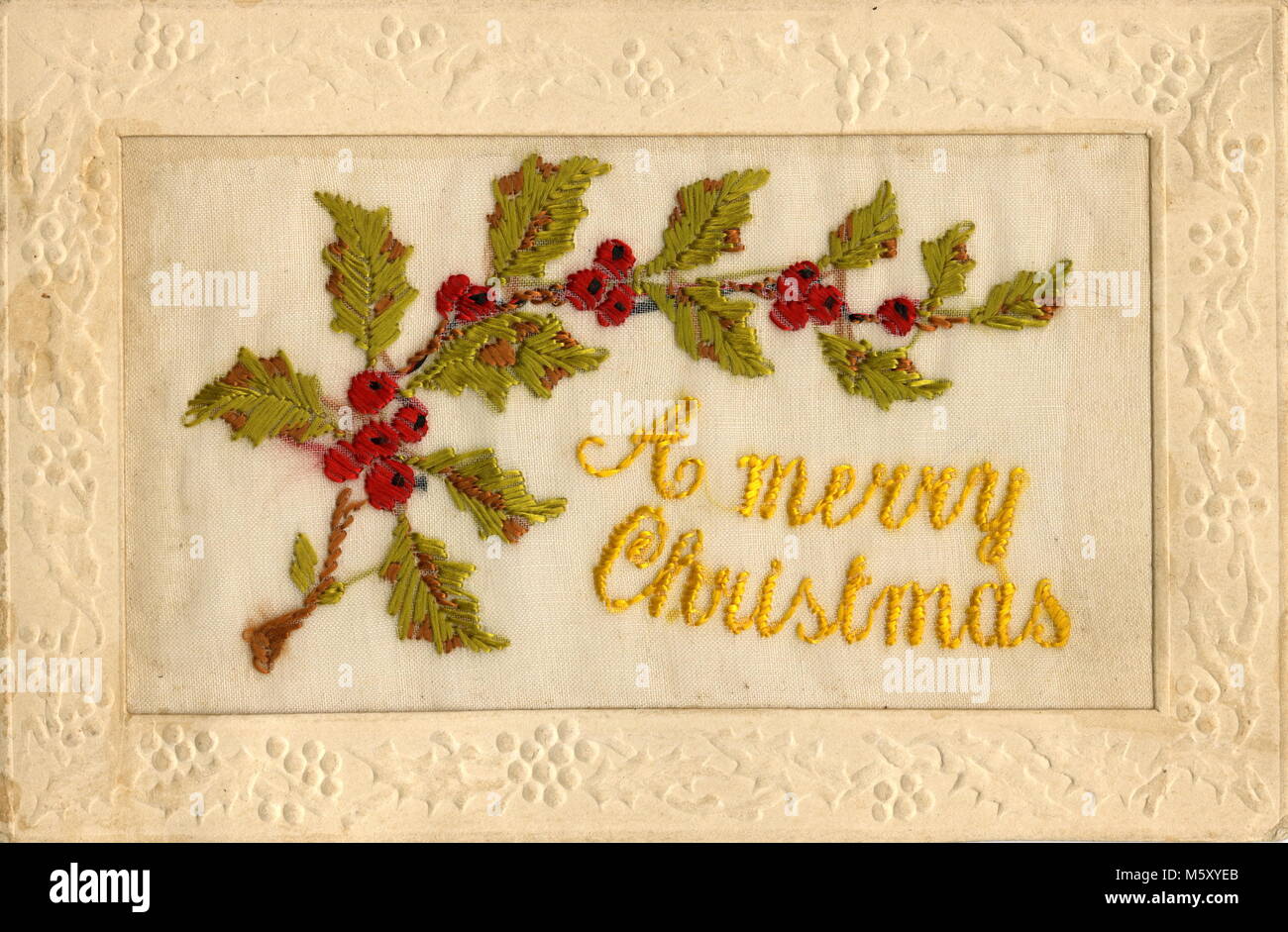 AJAXNETPHOTO. 1914-1918. WW1 EPHEMERA. - A SILK EMBROIDERED LETTER CARD DEPICTING HOLLY LEAVES AND BERRIES WITH THE NOTATION 'A MERRY CHRISTMAS' CONTAINED WITHIN AN EMBOSSED BORDER OF THE TYPE SENT BY SOLDIERS SERVING ON THE WESTERN FRONT TO RELATIVES IN THE U.K.  PHOTO:AJAX VINTAGE PICTURE LIBRARY REF:182602 1 Stock Photo