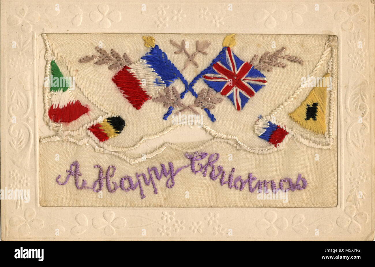 AJAXNETPHOTO. 1914-1918. WW1 EPHEMERA. - A SILK EMBROIDERED LETTER CARD DEPICTING THE CROSSED NATIONAL FLAGS OF GREAT BRITAIN AND FRANCE BORDERED WITH FLAGS OF THE ENEMY WITH THE NOTATION 'A HAPPY CHRISTMAS' CONTAINED WITHIN AN EMBOSSED BORDER OF THE TYPE SENT BY SOLDIERS SERVING ON THE WESTERN FRONT TO RELATIVES IN THE U.K.  PHOTO:AJAX VINTAGE PICTURE LIBRARY REF:182602 12 Stock Photo