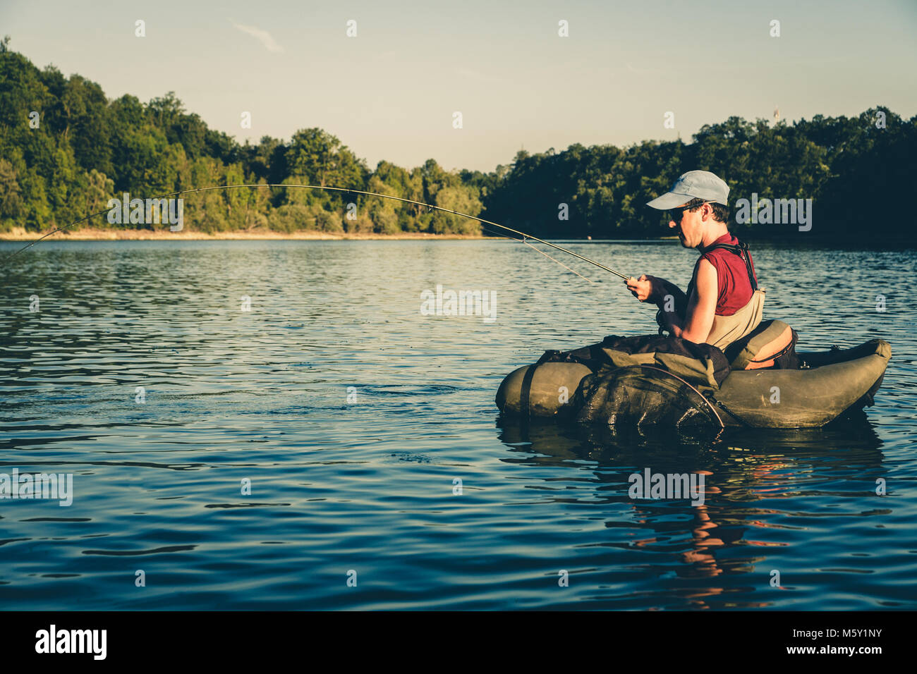 Fly Fisherman fishing for Trout while floating in a Belly Boat on Hi Hium  Lake, Cariboo Region, BC, British Columbia, Canada Stock Photo - Alamy