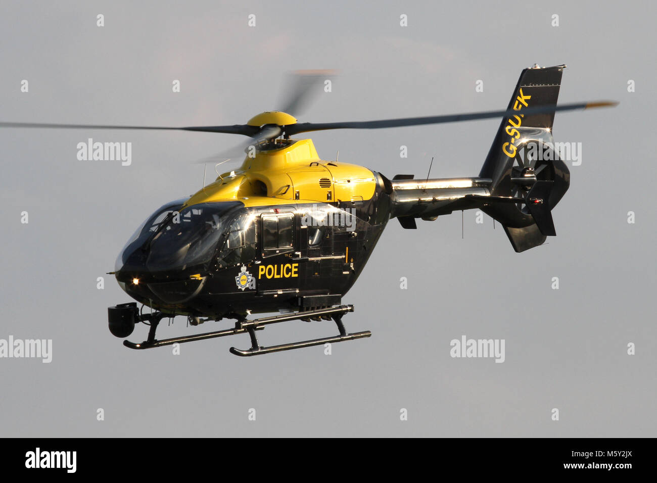National Police Air Service Eurocopter EC135 in the hover overhead Wattisham Airfield in Suffolk. Stock Photo