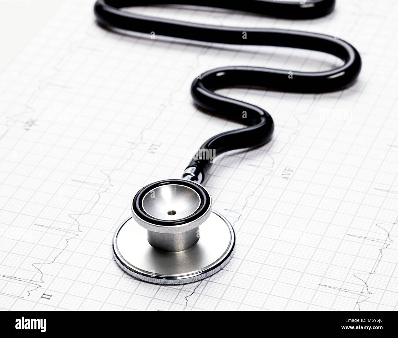 Stethoscope in the shape of heart beat on electrocardiogram Stock Photo