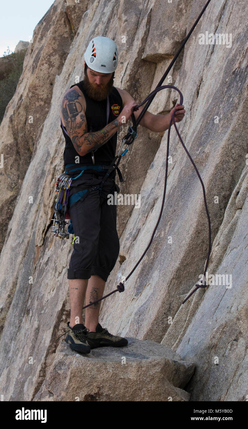 Rappelling. Tie knots at the end of your rope before rappelling and make  sure the rope is long enough to finish your rappel Stock Photo - Alamy