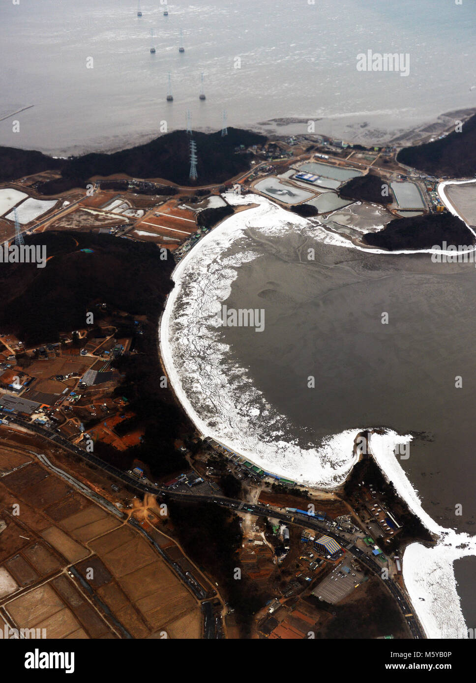 Aerial views above coastal South Korea during the winter season. Stock Photo