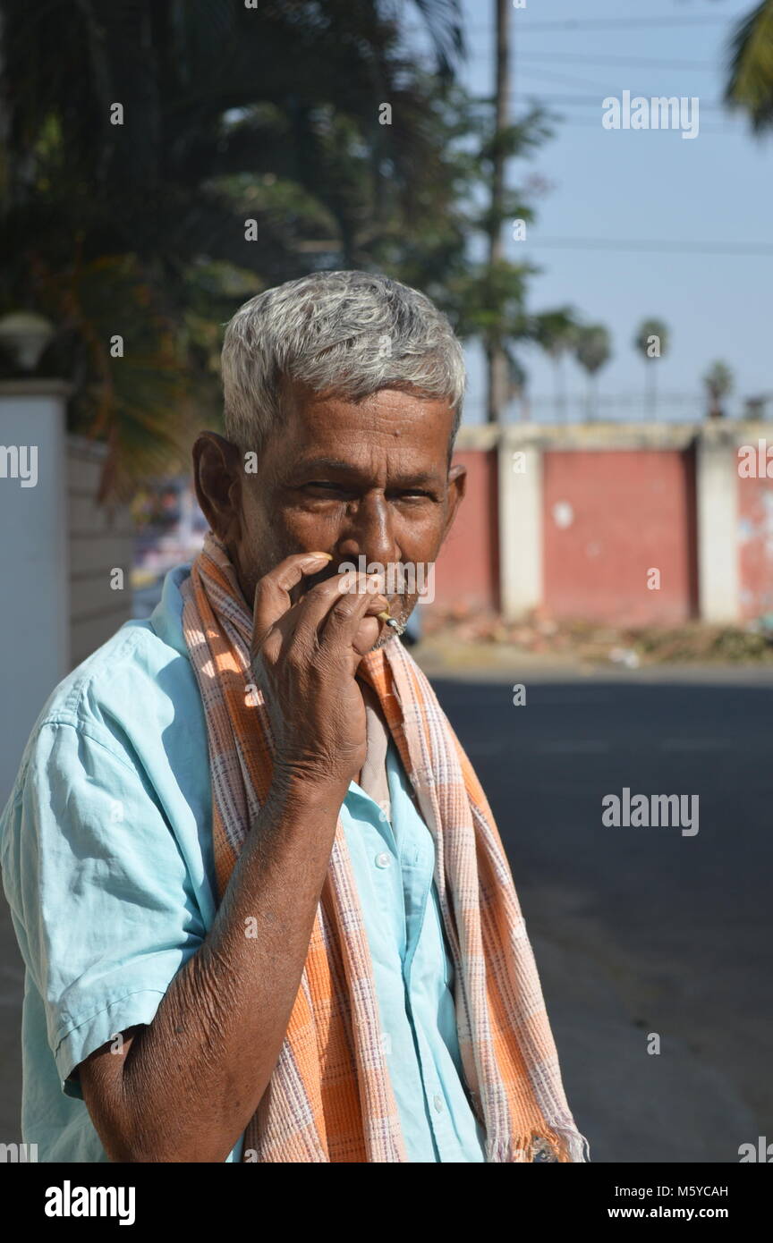 a person smoking cigarette with his hand ,smoking kills and causes cancer.avoid smoking Stock Photo