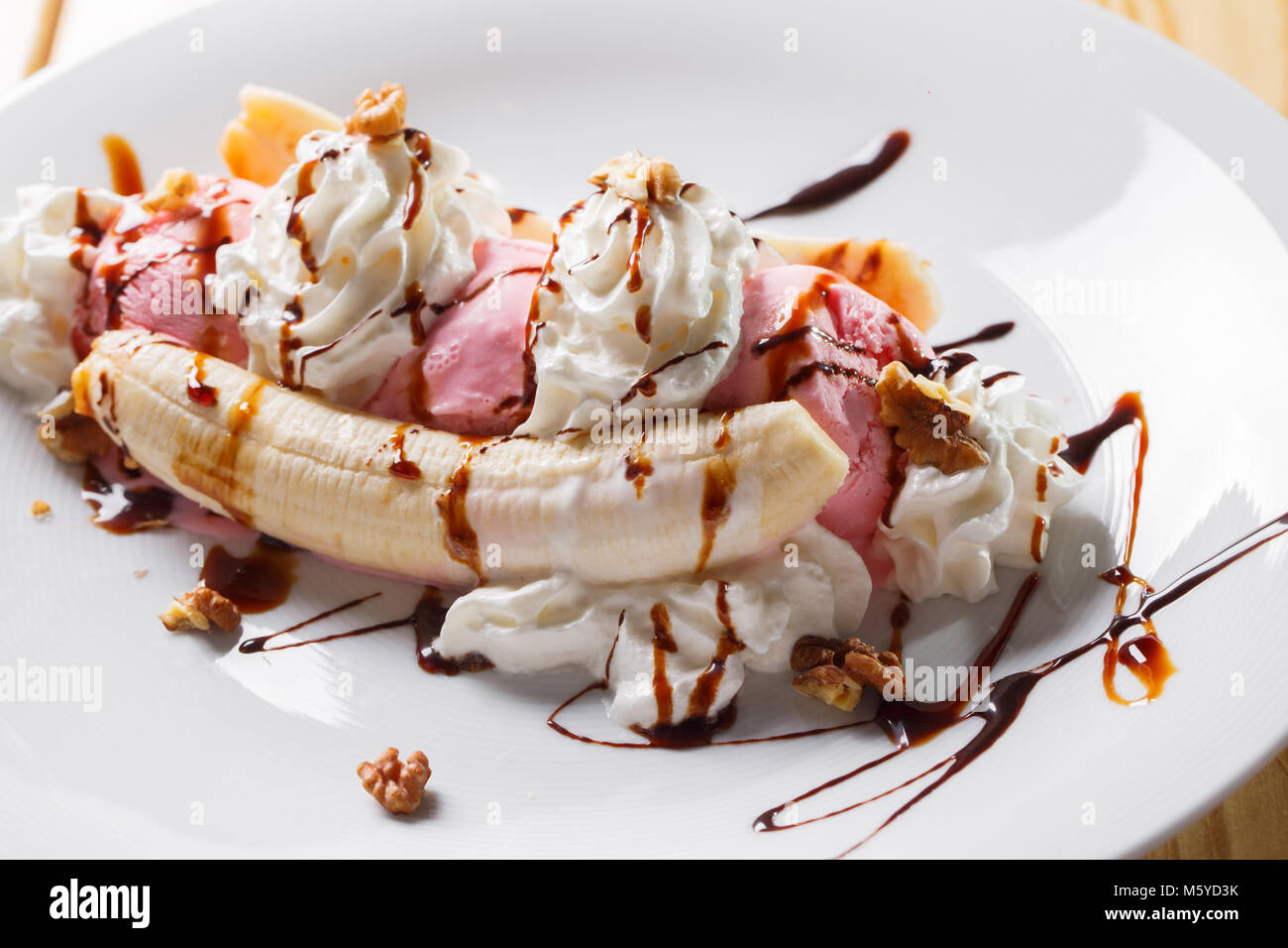 Banana split ice cream with whipped , nuts and cherry Stock Photo Alamy