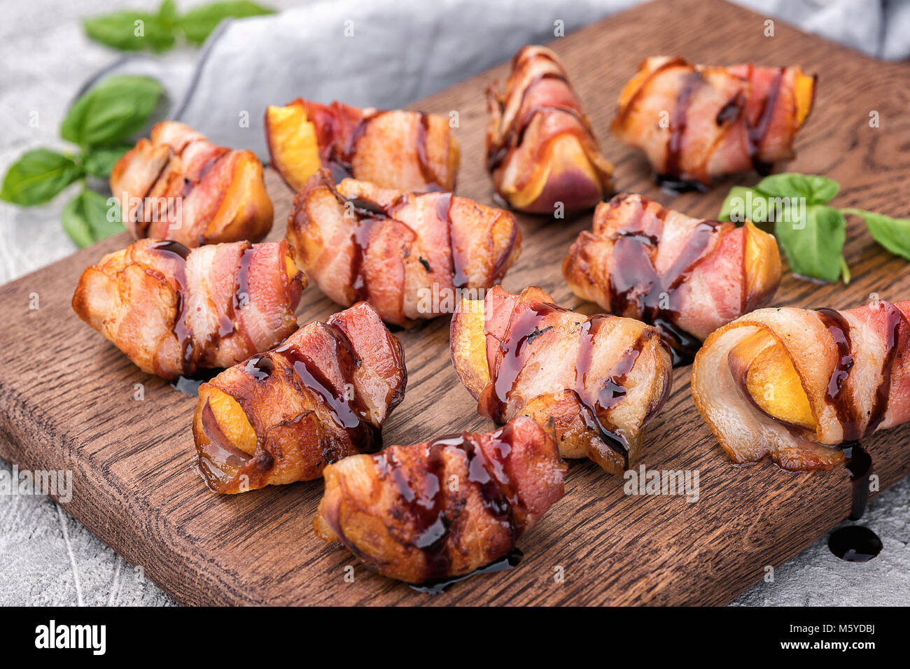 Grilled bacon wrapped peach with balsamic vinegar Stock Photo