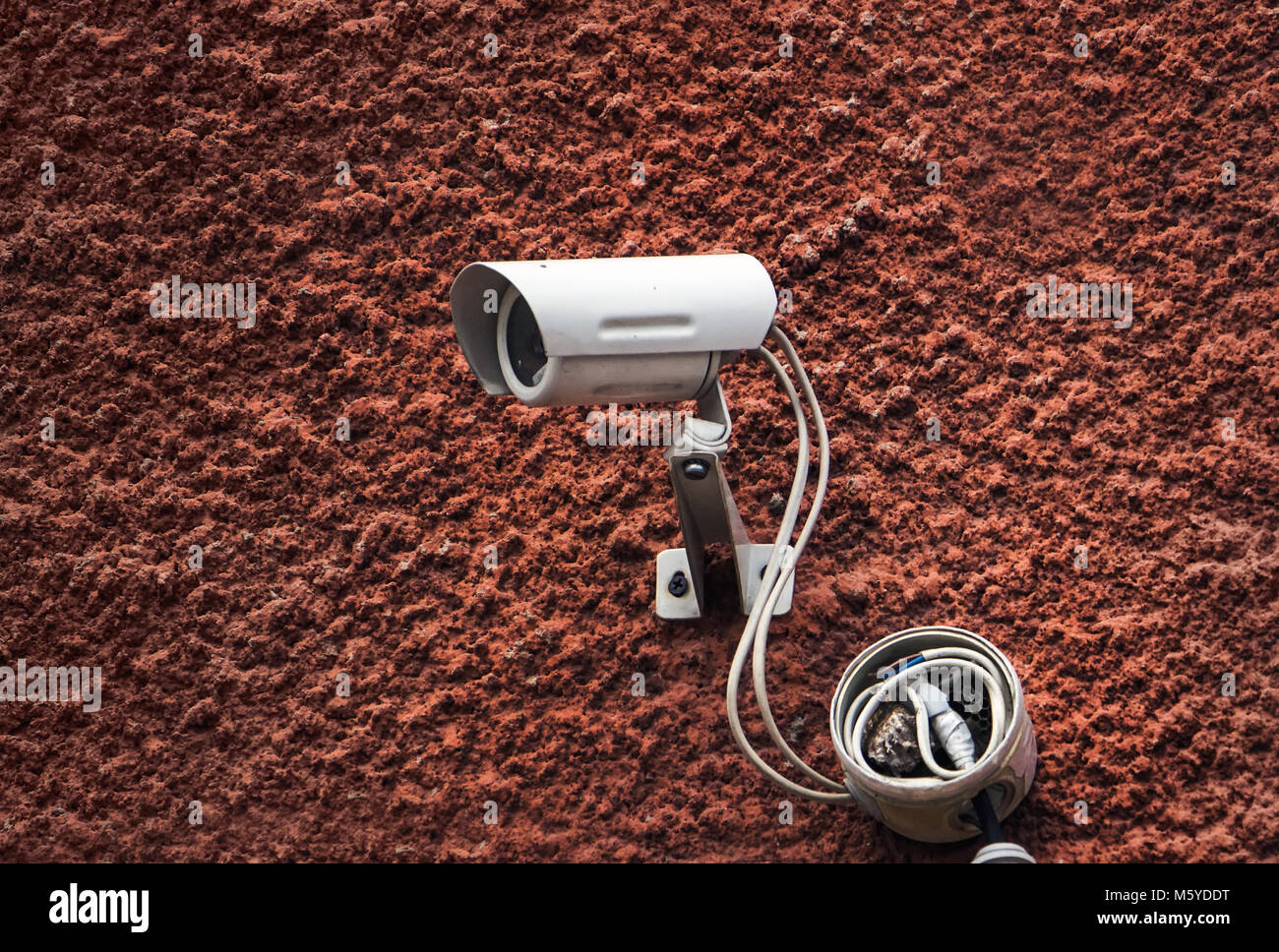 Security camera. wall of red color with the white of a video