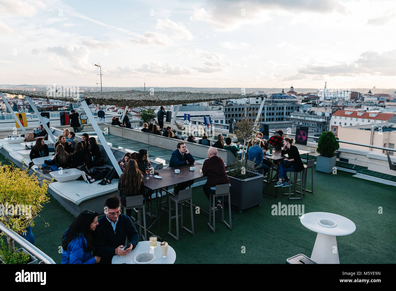 Madrid, Spain - November 3, 2017:  People enjoying at cafe on Circulo de Bellas Artes of Madrid rooftop at sunset. Stock Photo