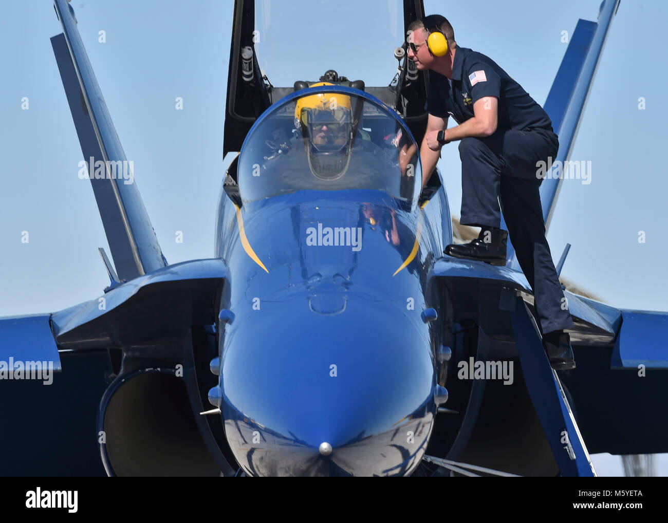 180224-N-ZC358-0721   NAF EL CENTRO, Calif. (Feb. 24, 2018) Blue Angels Crew Chief, Aviation Ordnanceman, Brandon Bates, prepares Lead Solo Pilot, Lt. Tyler Davies, for launch. The Blue Angels are scheduled to perform more than 60 demonstrations at more than 30 locations across the U.S. in 2018. (U.S. Navy photo by Mass Communication Specialist 2nd Class Jess Gray/Released) Stock Photo