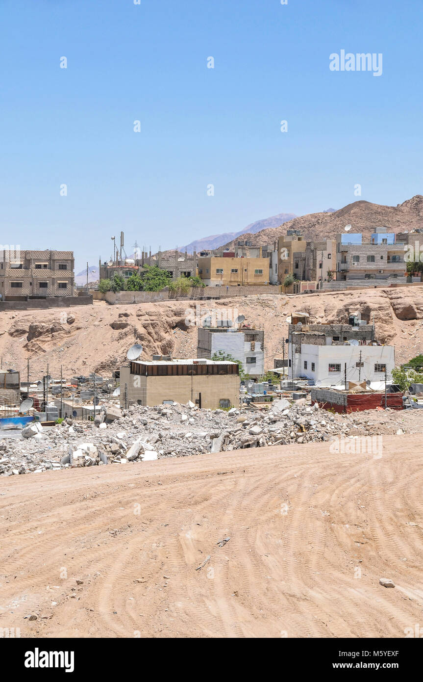 An informal settlement demolished in Aqaba Jordan with modern houses in