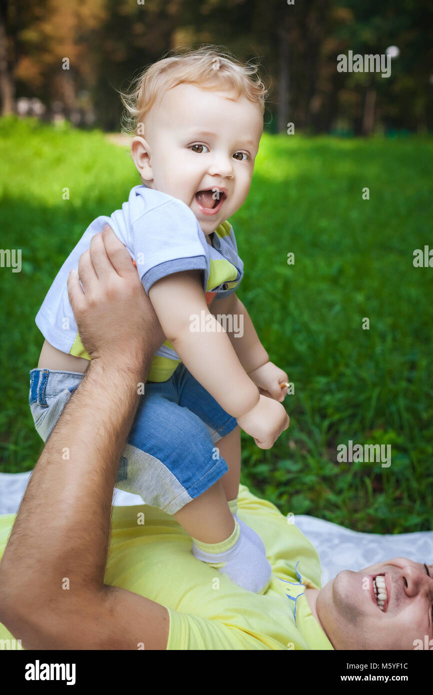 nice father and his son on grass Stock Photo - Alamy
