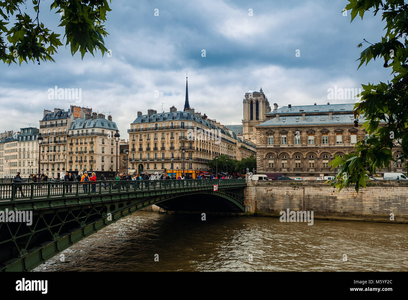 Paris Rivers Bridge People o the bridge over Seine river and typical parisian buildings on ...