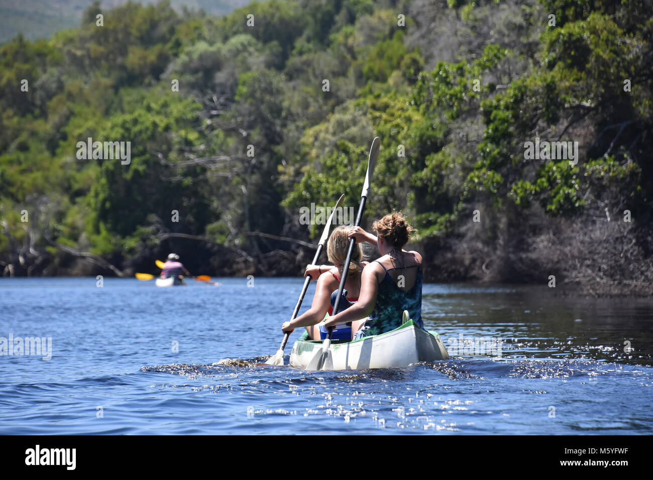Two female tourists Kayaking in a double kayak in Goukamma near Knysna on the Garden Route in South Africa Stock Photo
