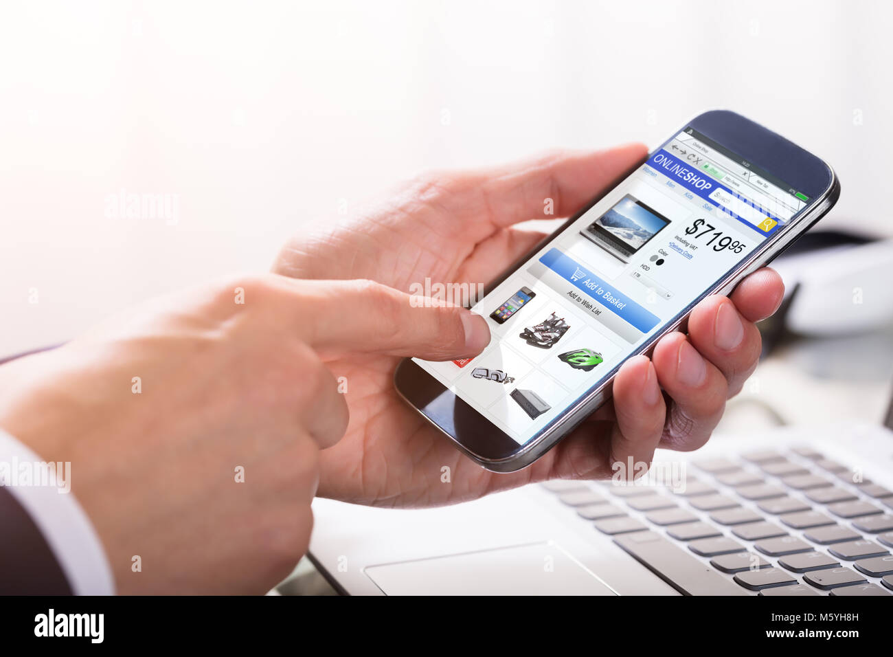 Close-up Of A Businessperson's Hand Shopping Online On Smartphone Stock Photo