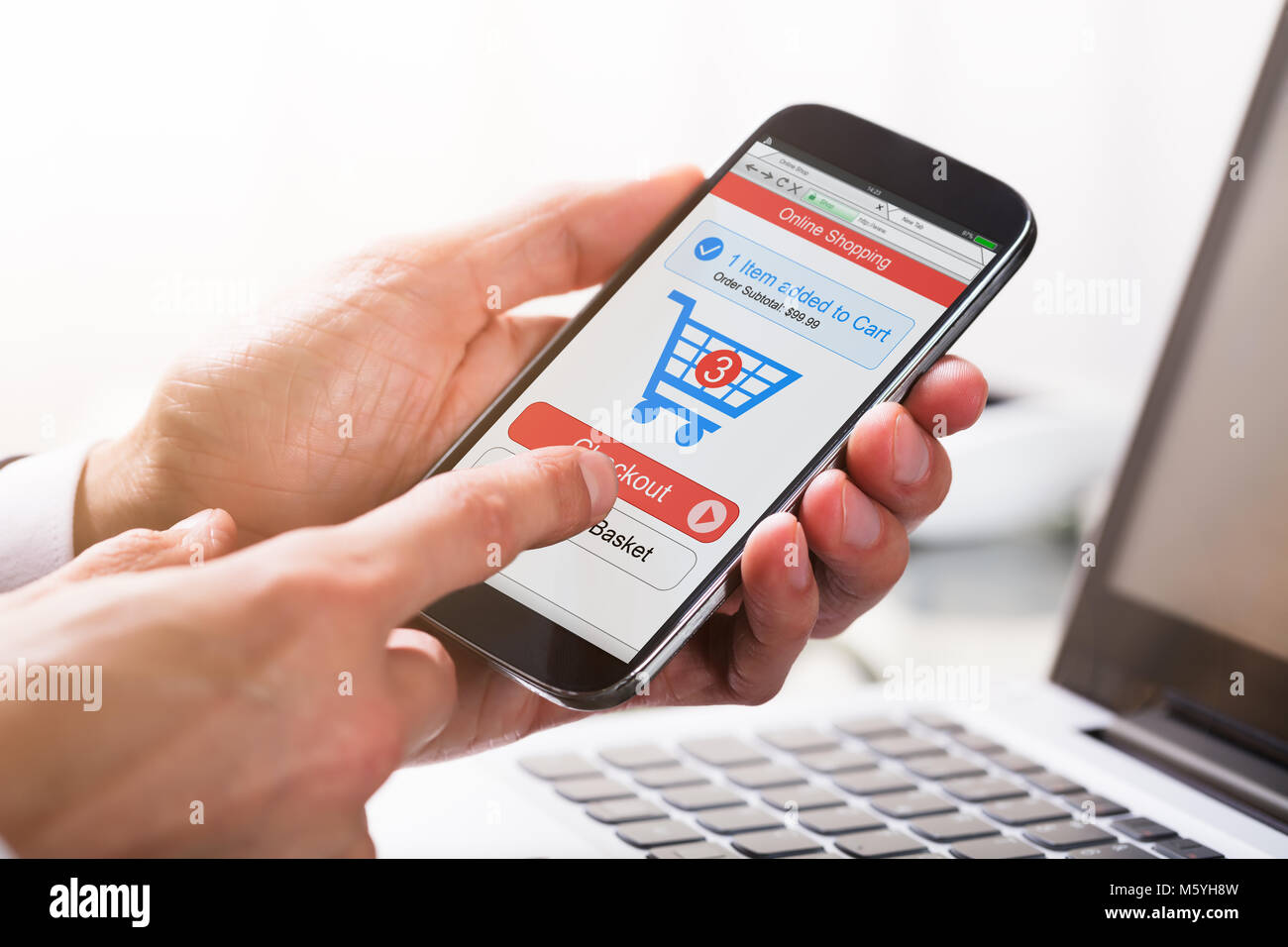 Close-up Of A Businessperson's Hand Clicking On Checkout Option While Shopping On Mobile Phone Stock Photo