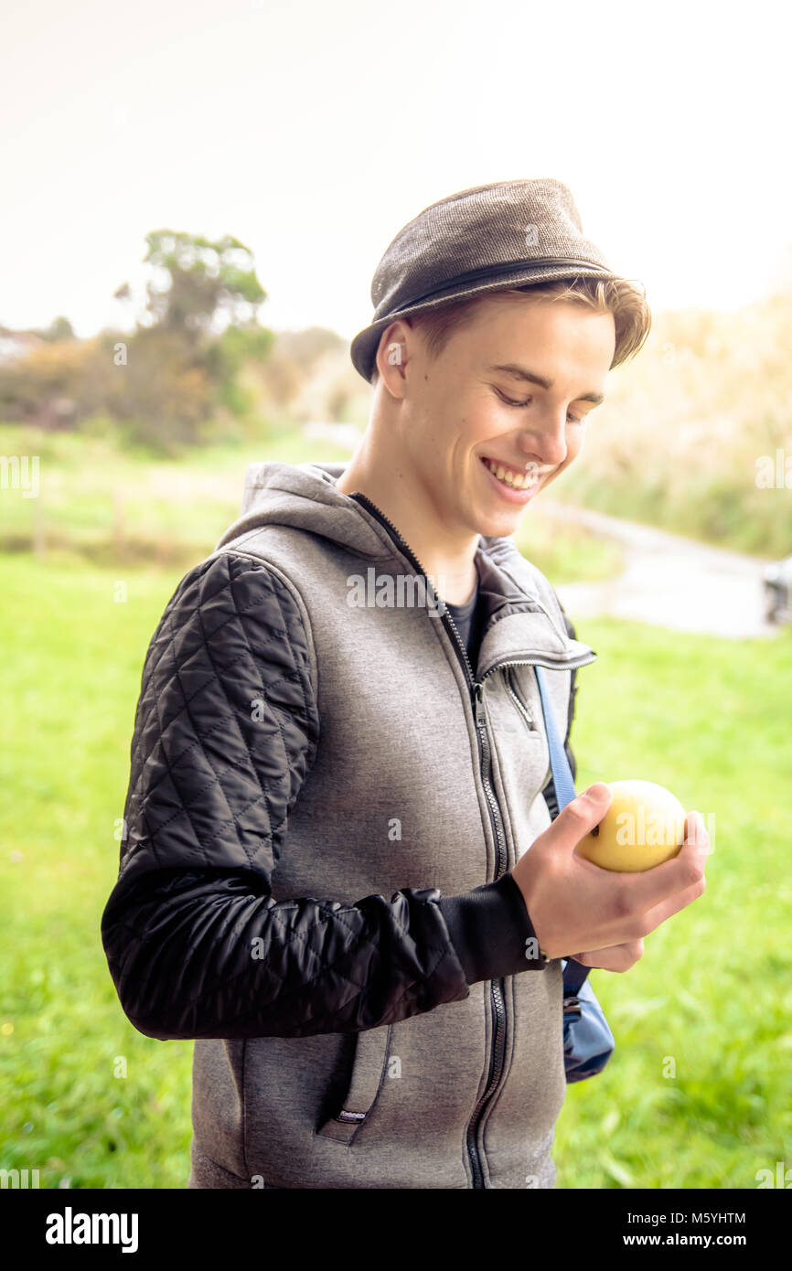 Man smiling and looking to an apple Stock Photo