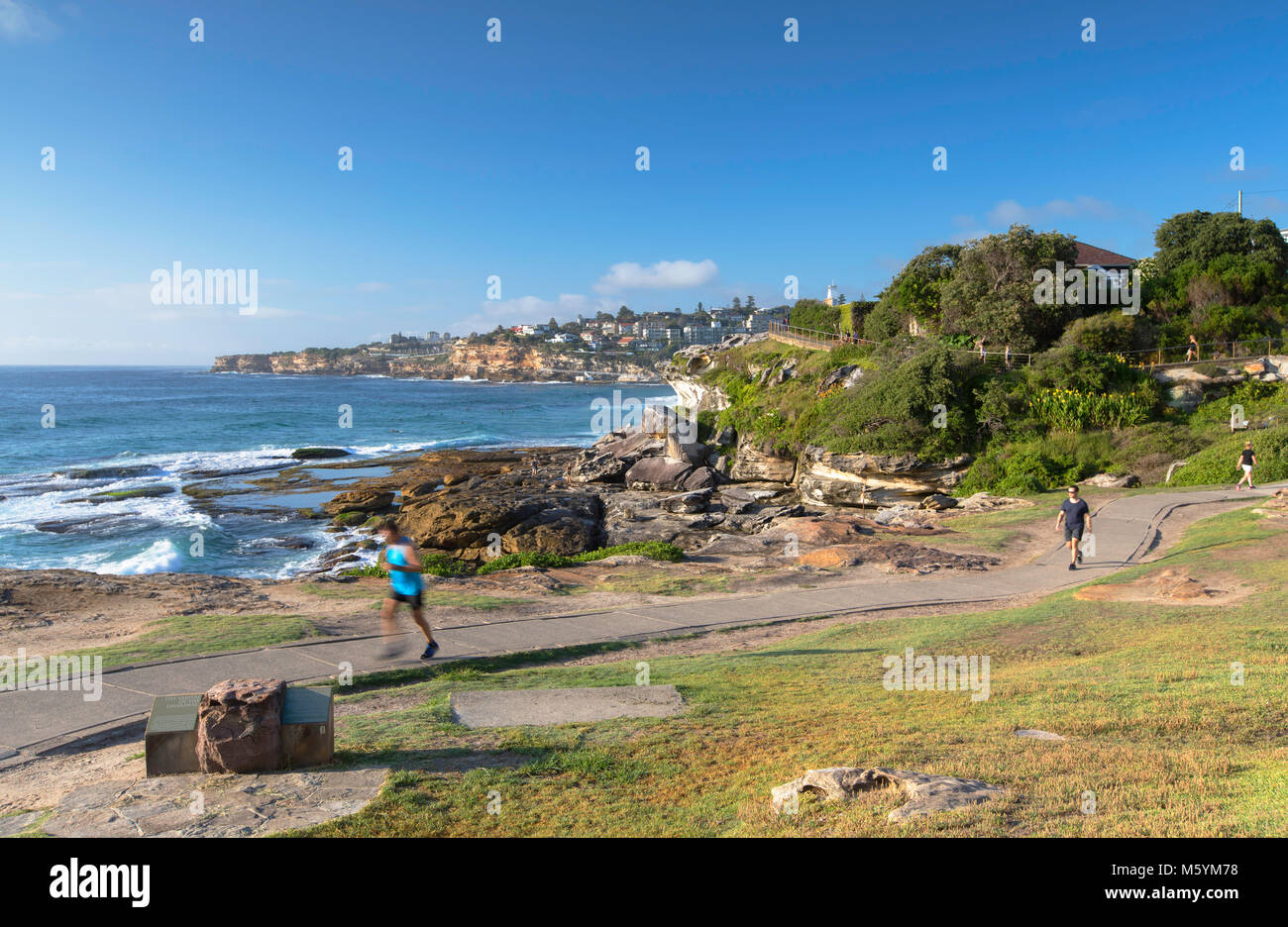 People jogging along Bondi to Bronte walk, Sydney, New South Wales, Australia Stock Photo
