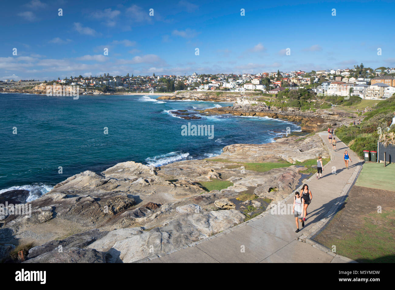 People jogging along Bondi to Bronte walk, Sydney, New South Wales, Australia Stock Photo