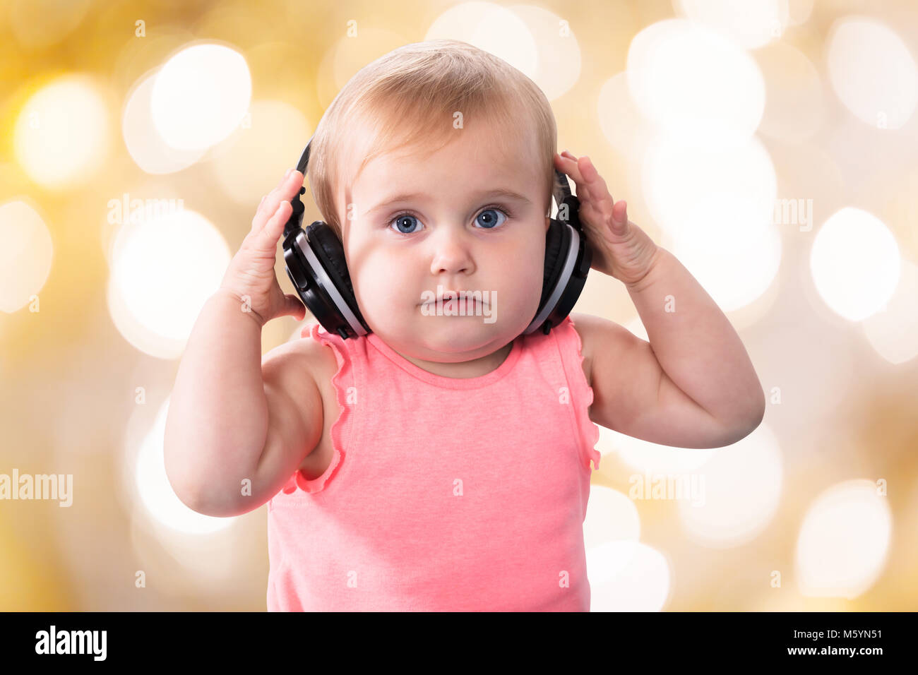Portrait Of A Cute Baby Girl With Headphone Stock Photo