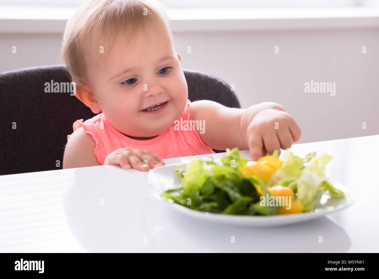 Closeup Of A Cute Baby Girl Eating Vegetable Stock Photo Alamy